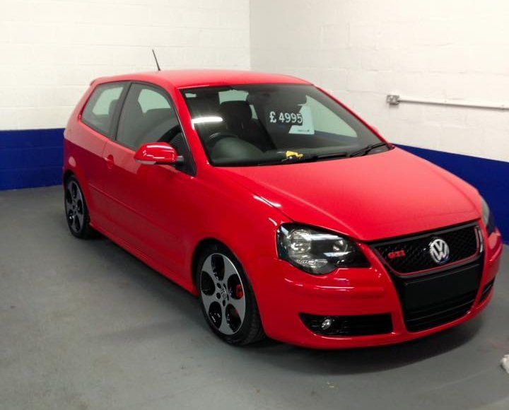 a red Volkswagen sedan car